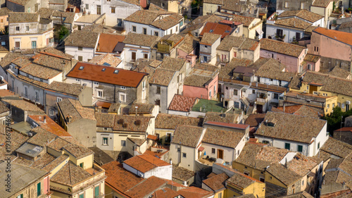 Canvas Print Aerial view of a Mediterranean village featuring a dense cluster of historic houses with traditional terracotta tiled roofs