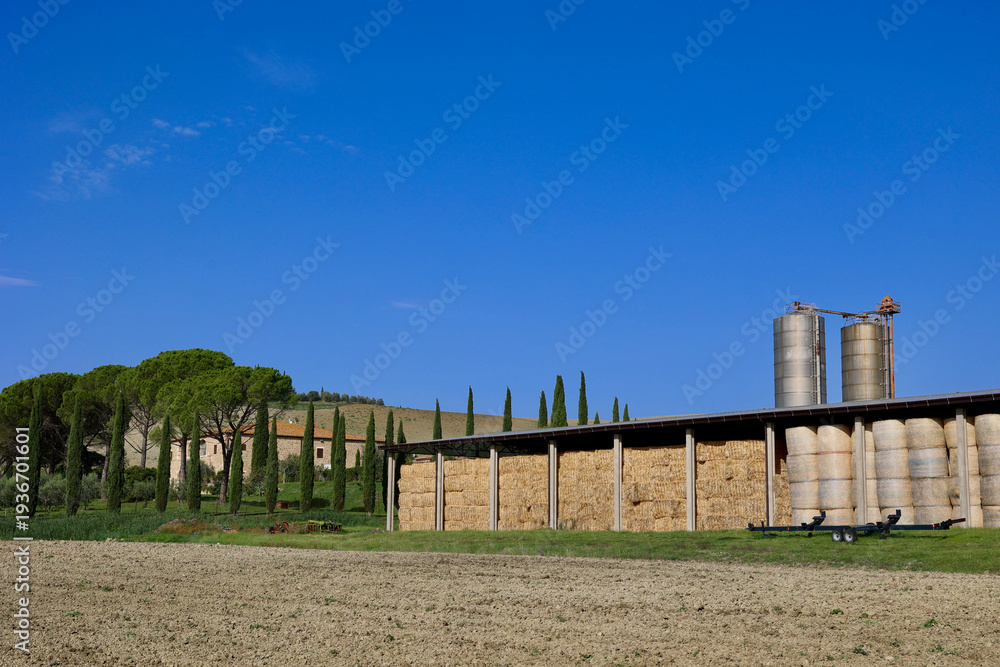 Naklejka premium Hay Storage Barn and Farm Silos in the Tuscan Countryside near Pienza, Italy