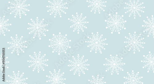 Beautiful winter pattern showcasing various white snowflake designs on a soft light blue background perfect for seasonal holiday decorations.