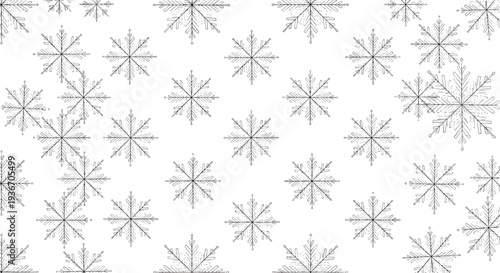 Intricate seamless pattern showing various detailed grey snowflakes falling against a white background for a sophisticated winter design.