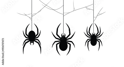 Three black spiders hanging from a cobweb in a spooky scene