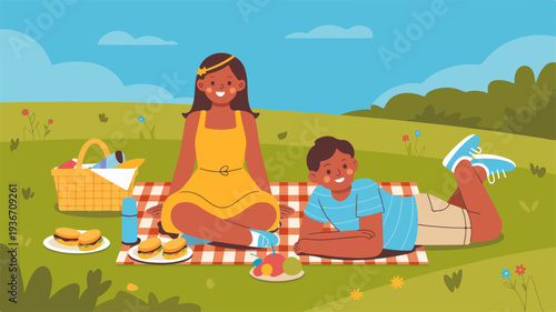 Happy family having outdoor picnic on green grass with food and drinks on a sunny day