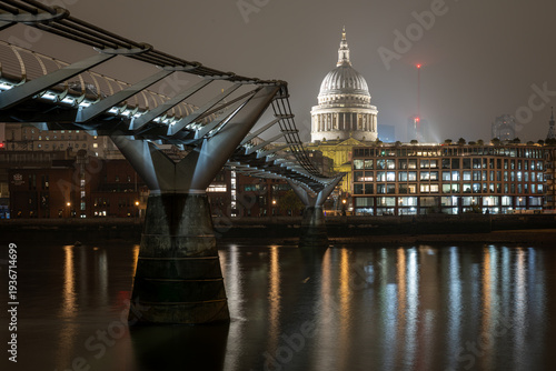 St Pauls Cathedral illuminated at night viewed from Millennium Bridge London
