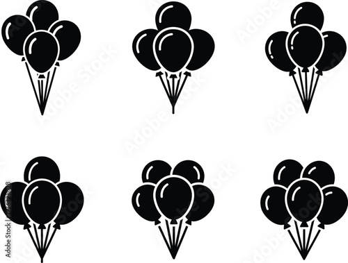 Several bunches of tied black balloons floating up  party decoration