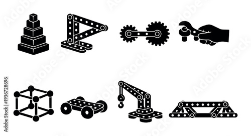 Metal construction toy parts arranged on a dark studio background