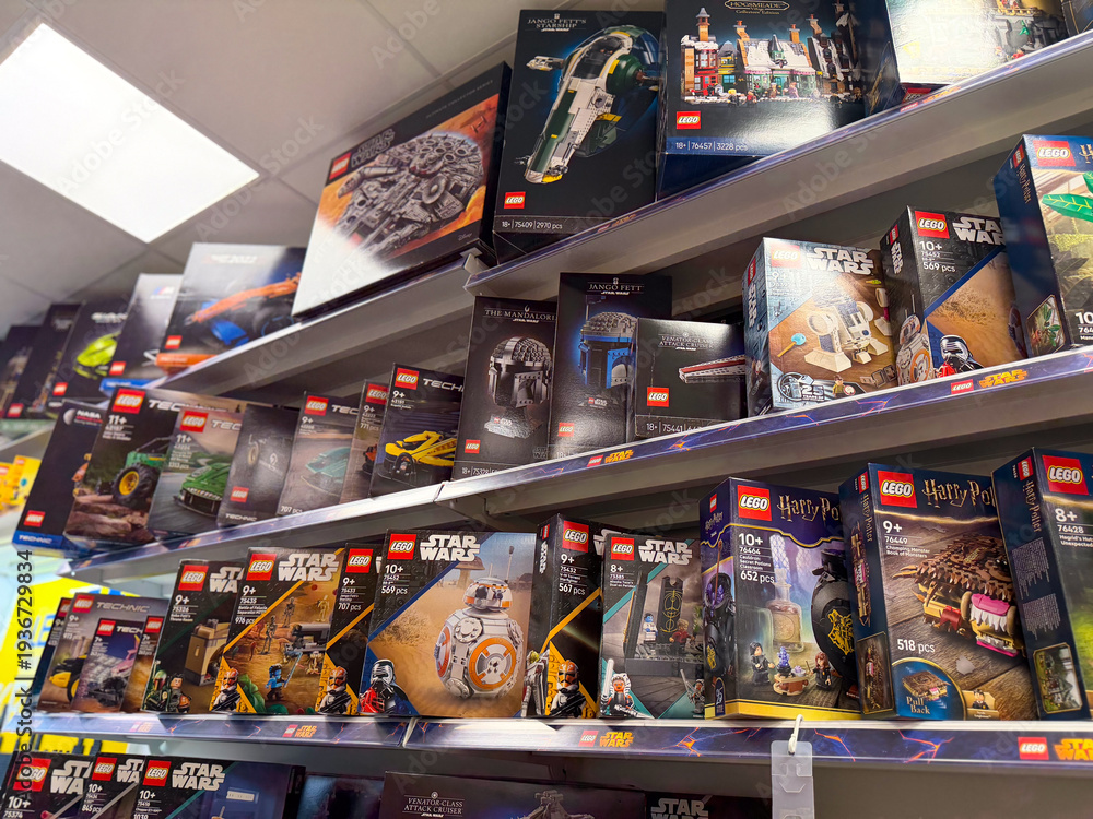 Naklejka premium Shelves of boxed lego sets in retail store