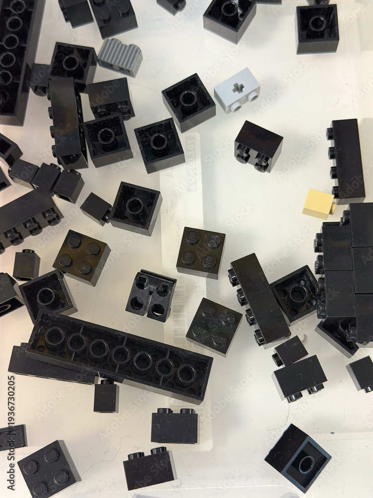 Naklejka premium Scattered black building bricks