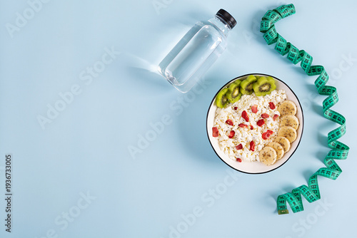 Healthy breakfast bowl with cottage cheese, fresh kiwi, banana slices and dried strawberries