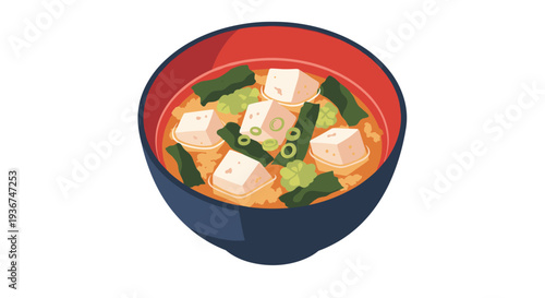 Traditional Japanese miso soup is served in dark bowl with visible cubes of soft tofu pieces of green seaweed and chopped scallions.