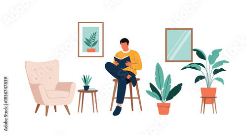 Young man sitting on a wooden stool while reading a book in a room surrounded by various green potted plants and framed art.