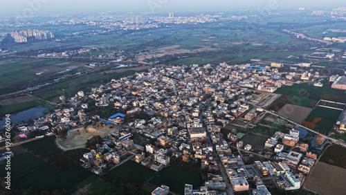 Canvas Print Aerial view of a dense residential neighborhood surrounded by agricultural field
