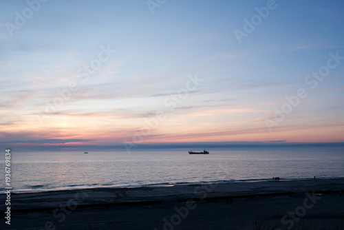 Ship off the Coast – documentary style, real world, authentic situation, natural light, genuine moment captured by human photographer, no ai