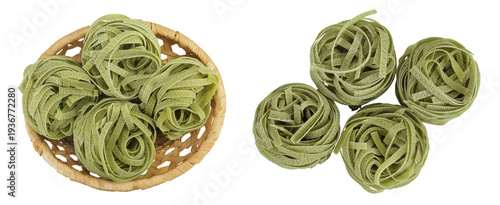Raw tagliatelle green pasta with spinach in a wicker basket isolated on white background. Top view. Flat lay.