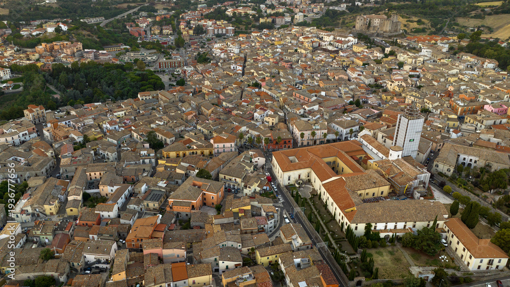 Fototapeta premium Aerial view of Melfi, a town in Basilicata, Italy. Historic Italian village with clustered stone houses and terracotta roofs. The dense urban layout showcases traditional Mediterranean architecture.