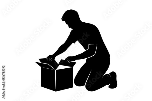 Silhouette of a caucasian young male unpacking box, kneeling in curiosity.