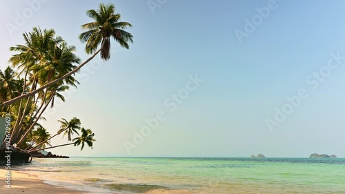 Tranquil scene of tropical beach with coconut trees in the summer time. Wonderful paradise relaxing shoreline with turquoise clear water under blue sky at Koh Samui, Thailand.