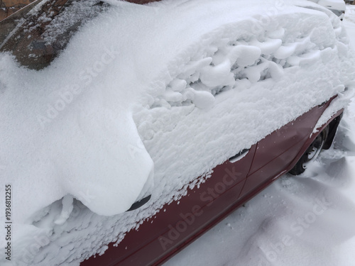 Fotografie Fragment of side and front part parked snowbound red car
