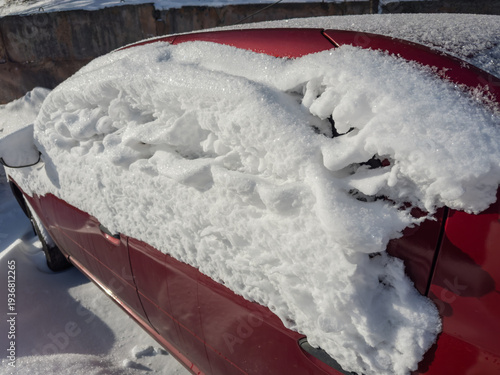 фотографія Side part of parked snowbound red car in sunny day