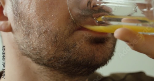 Close up of a diabetic man sweating and trembling while drinking orange juice to quickly raise blood sugar levels, illustrating hypoglycemia symptoms and urgent self care response.