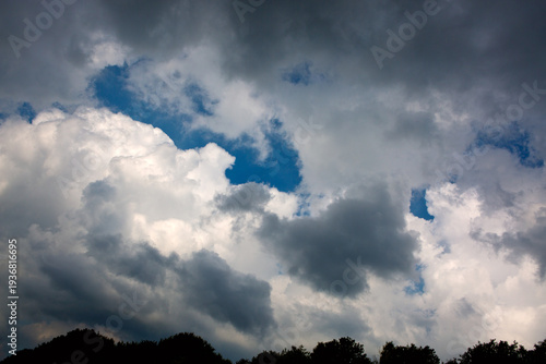 Gray rain clouds and blue sky in summer day.