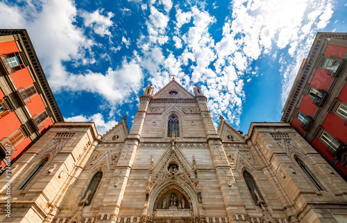 “Cattedrale di Santa Maria Assunta“ catholic Cathedral in Naples (Italy) with impressive renovated facade. Wide angle frog perspective of important church in the old town “Centro storico Napoli“ 