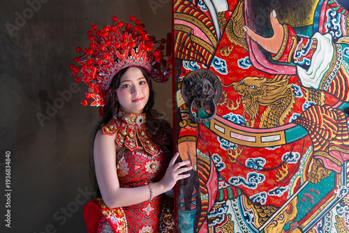 Quadro em tela Young woman in traditional red Chinese costume with elaborate headdress standing