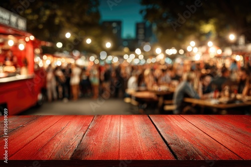 Rustic red table with blurred night market scene