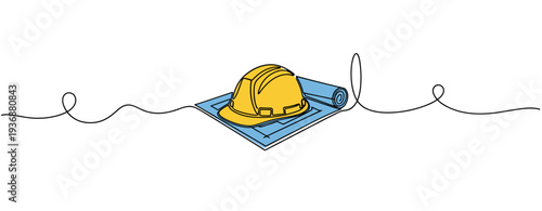 Construction helmet resting on rolled blueprint in studio setting. no editable stroke