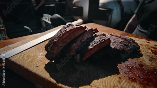 Extreme close-up of a hand squeezing a yellow spray bottle nozzle releasing a fine liquid mist against a colorful outdoor background