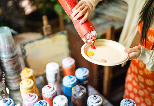 Joyful young adult asian woman creative painting workshop art therapy mental health at garden cafe