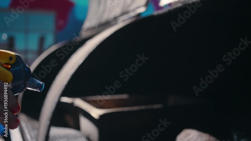 Overhead view looking down inside a barrel smoker at four large briskets arranged on the grill grate in dark moody dramatic lighting