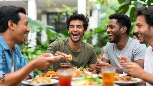 Group of diverse friends laughing and enjoying healthy brunch with fresh fruits and drinks outdoors