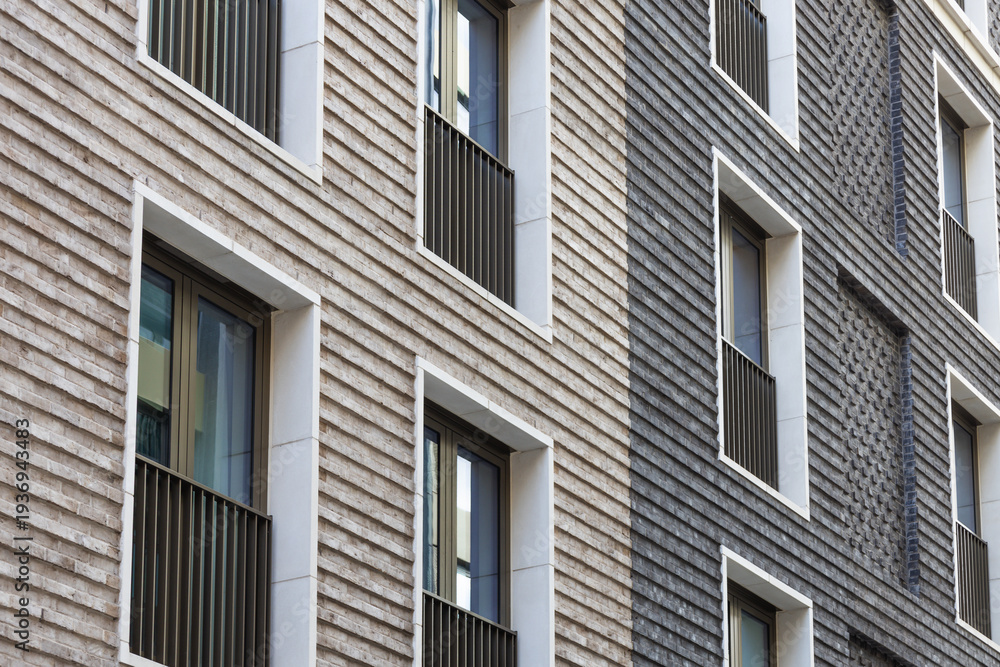 Obraz premium Modern brick facade with textured cladding and windows