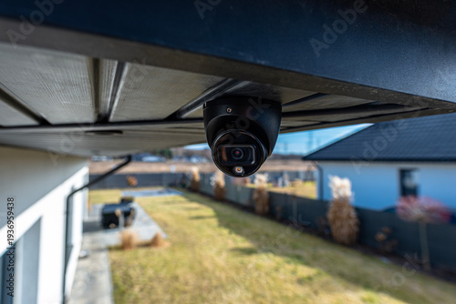 Dome security camera monitoring a residential property