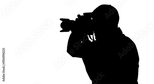 Silhouette of a photographer holding a camera, capturing a moment against a bright white background.