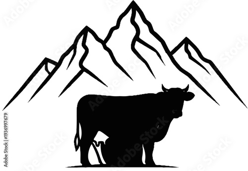 Silhouette of a cow standing before jagged mountain peaks in black and white