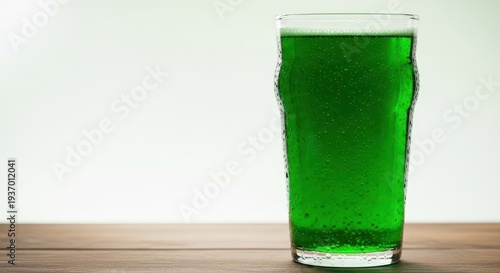 Cold, refreshing, vibrant green ale filling a classic, clear glass, resting on a wooden surface, ready for celebration, holiday, celebration, gathering