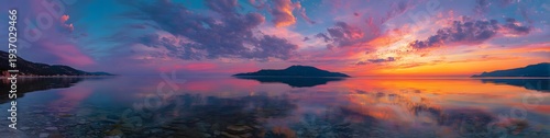 The serene beauty of a sunset over a calm lake, with vibrant colors reflected in the water