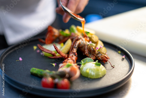 Slika na platnu Chef plating gourmet lobster dish with sauce