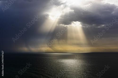 Sunbeams breaking through storm clouds over Mediterranean Sea