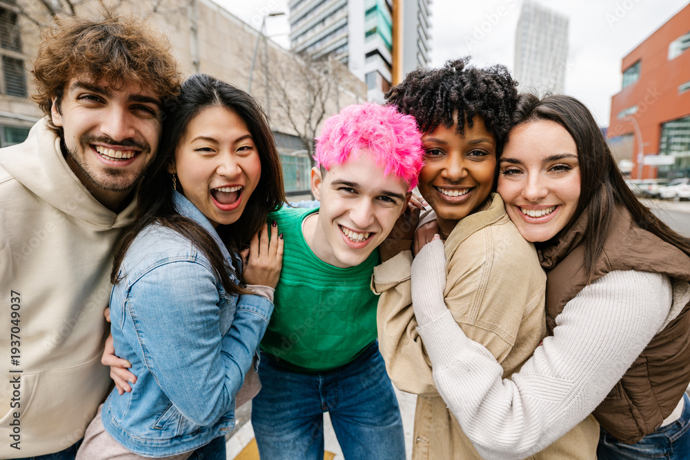 Obraz premium Young multiracial friends posing closely for group photo. Cheerful students enjoying time together outdoors. Youth community and unity concept.