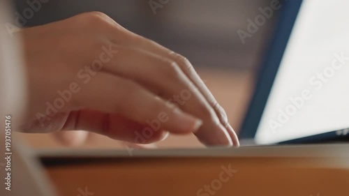 Fingers tap keyboard. Nighttime writing in cozy suite. Gentle illumination creates serene environment for creative writing. Intimate scene of fingers poised over keys in peaceful hotel setting