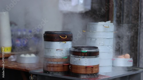 Steaming bamboo steamers at street breakfast shop, traditional Chinese morning food in busy city life with local culture