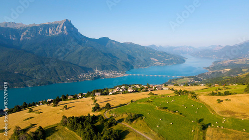 Aerial summer view of Lake Serre-Poncon in the French Alps and Savines-le-Lac village with Grand Morgon peak in Hautes-Alpes, France