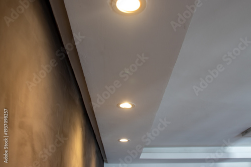 Foto Detail of recessed ceiling lighting with LED spotlights lit in a residential interior