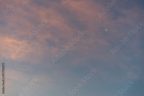 Pink cloud sunset with crescent moon