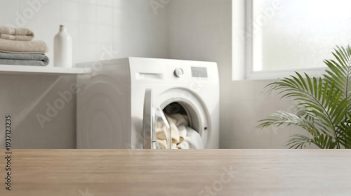 Wooden Table Top Foreground with Blurred Laundry Room and Open Washing Machine Interior Mockup