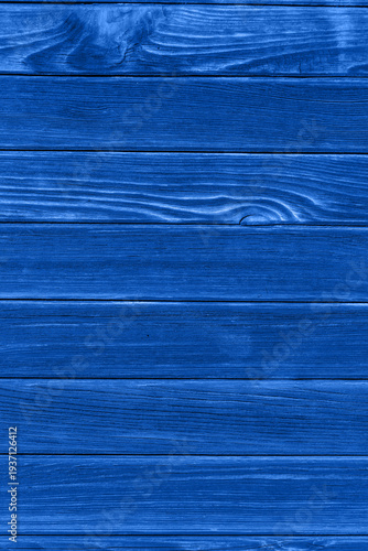 Dark blue wooden planks laid horizontally create a rustic textured background...