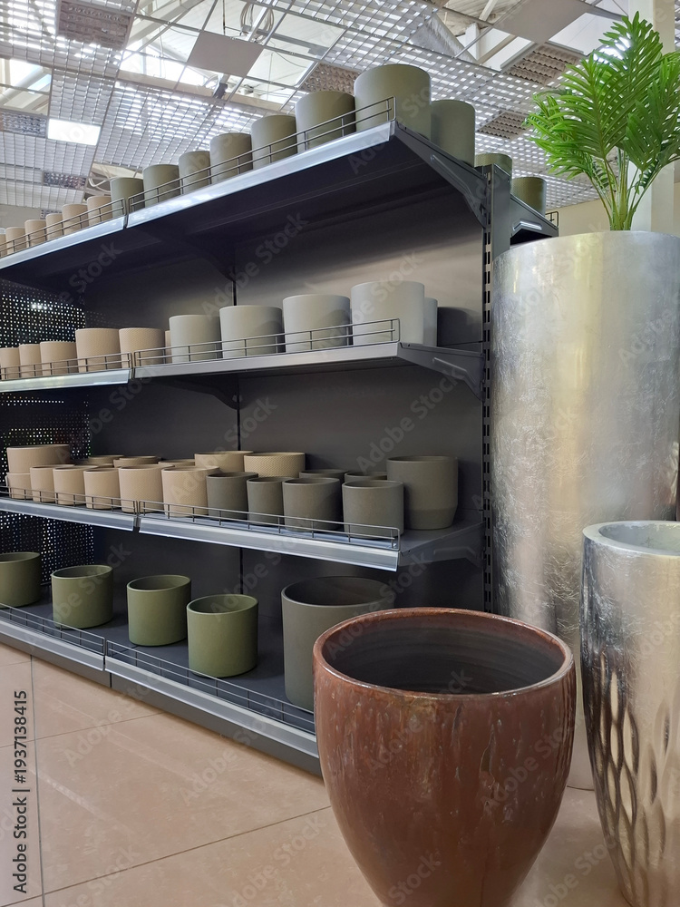 Fototapeta premium Flower pots on supermarket shelves. Many ceramic products in flower shop