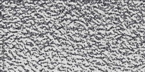 Detailed close up of a textured metallic surface with a rough pitted and speckled gray and white pattern creating a strong industrial or abstract background element